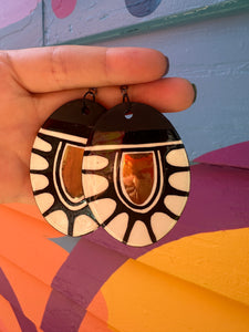 Large black and white earrings with gold accents